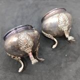 Pair of silver metal salt cellars with lion decor base