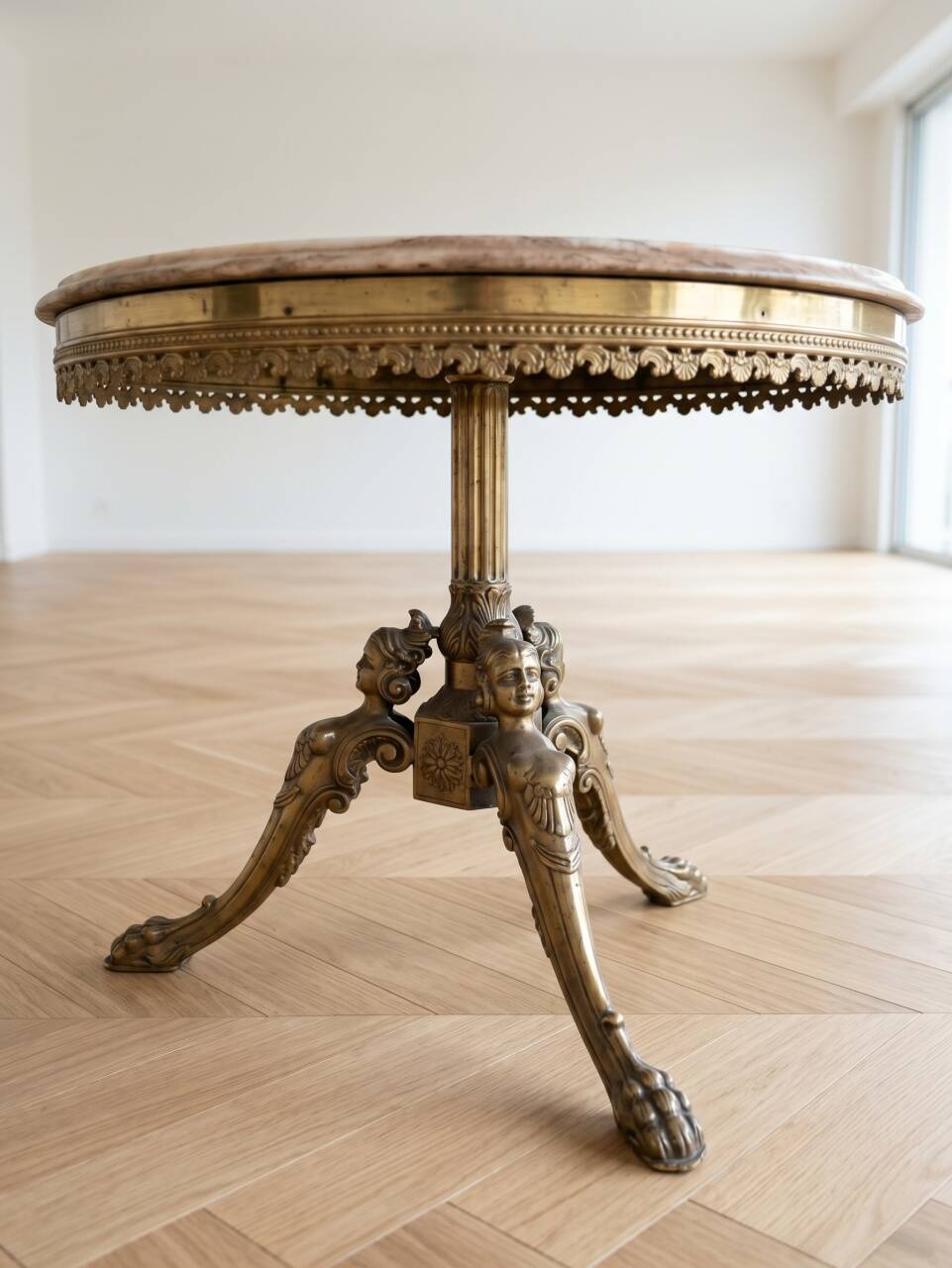 Round marble coffee table with a gold base in classic style.