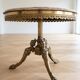 Round marble coffee table with a gold base in classic style.