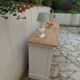 Craft furniture enhanced in pearl gray, shelves and top in raw wood.