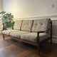 Vintage three-seater sofa — wood and sculptural backrest