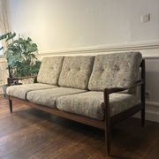 Vintage 3-seater wooden sofa with sculptural backrest.