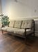 Vintage three-seater sofa — wood and sculptural backrest