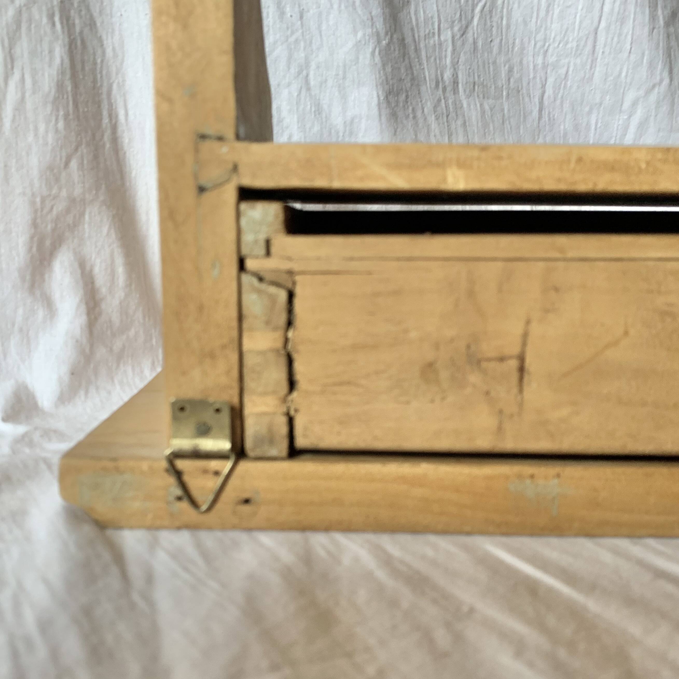 Old small hanging shelf in solid wood