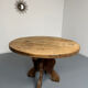 Round table in solid wood, thick top, vintage brutalist style from the 1960s.