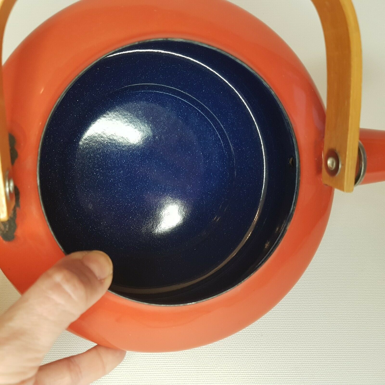 Orange and bamboo enamelled metal teapot in the 1970s