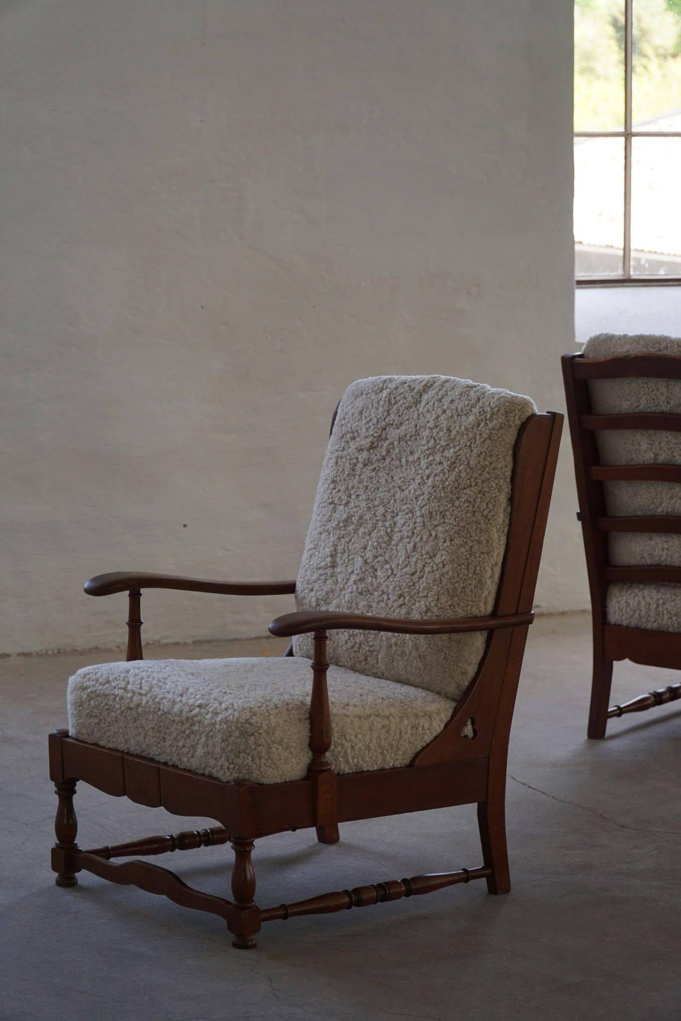 Modern Danish design, a pair of high-backed armchairs in oak and lambswool, 1950s.