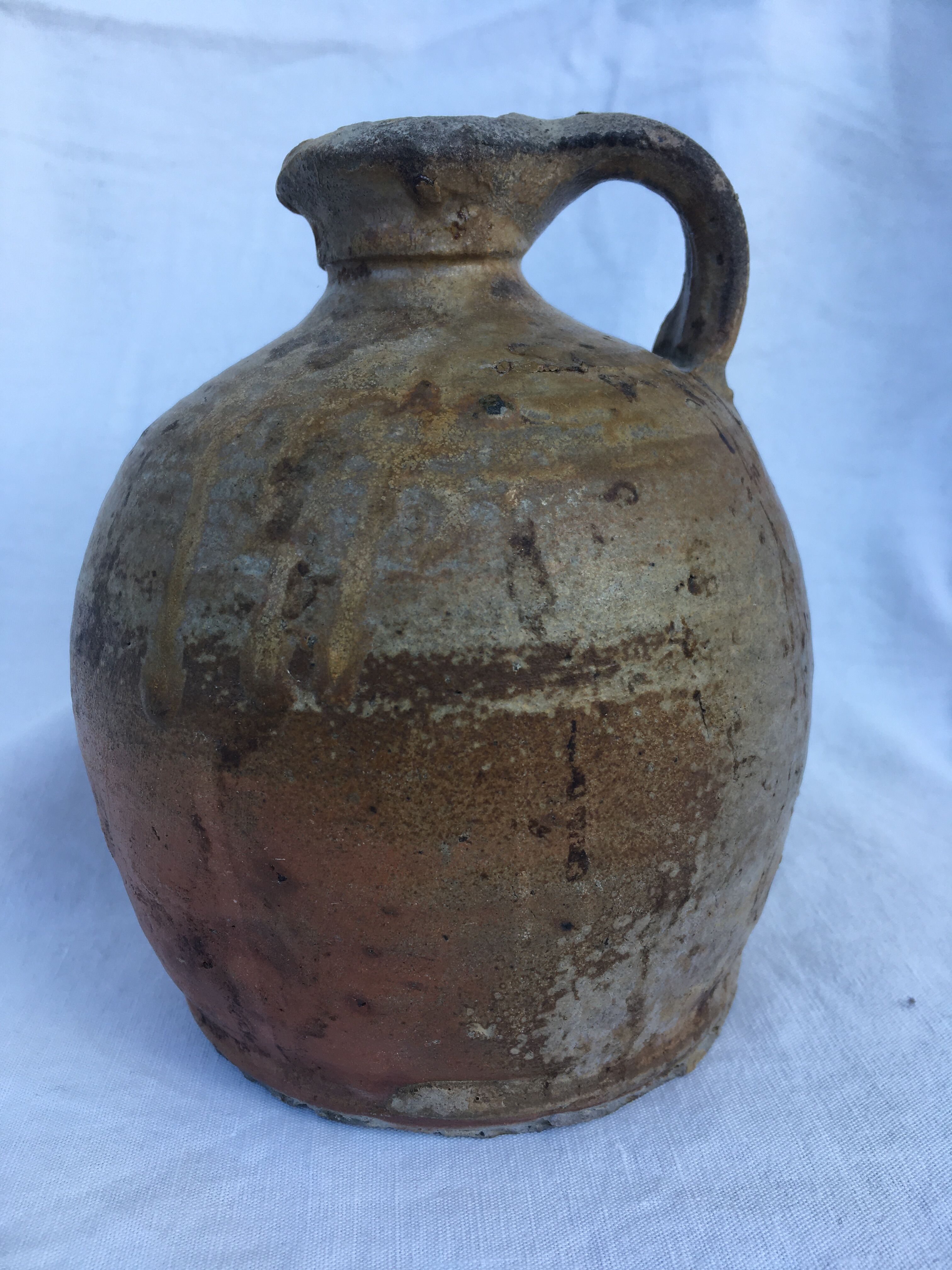 Ancient jug in glazed sandstone