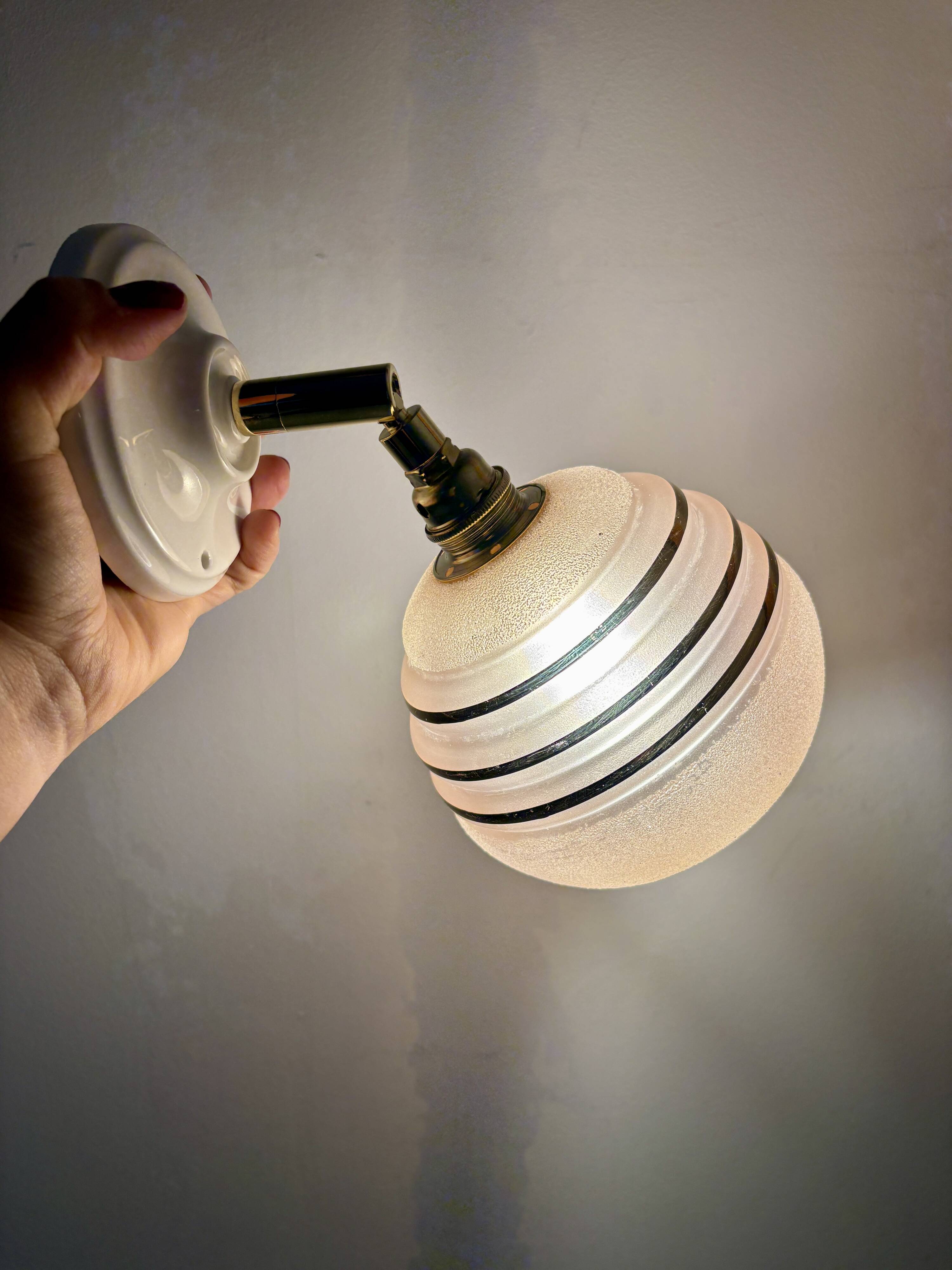 Vintage globe wall light in frosted pink and gold glass.