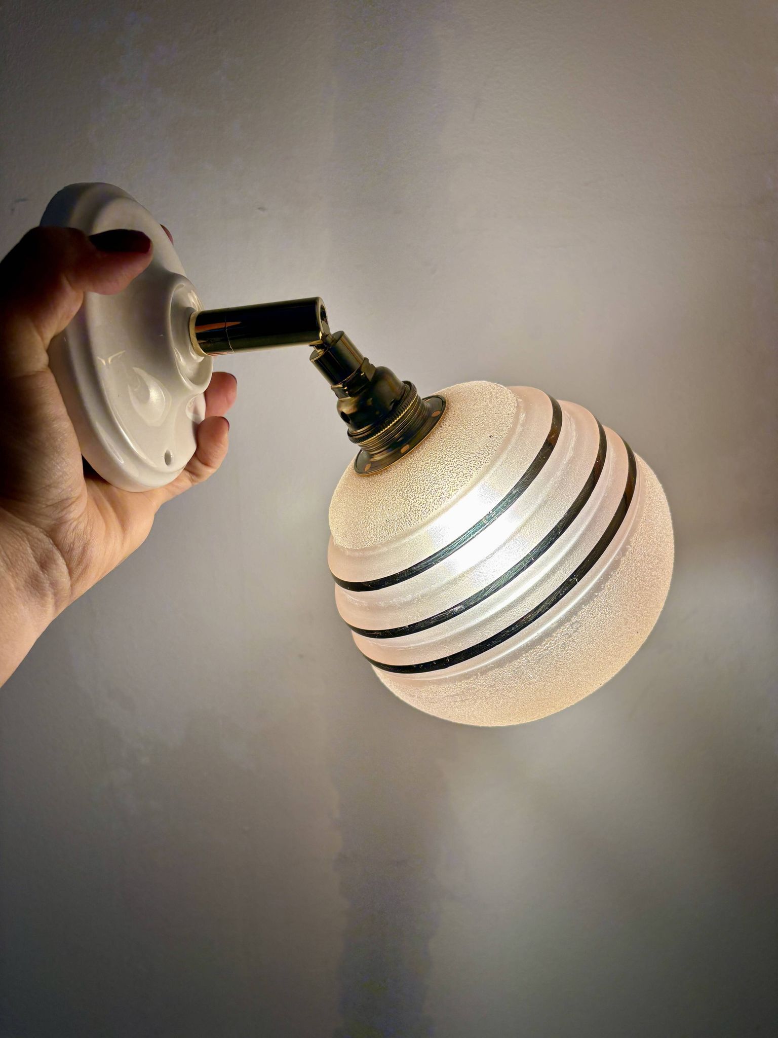 Vintage globe wall light in frosted pink and gold glass.