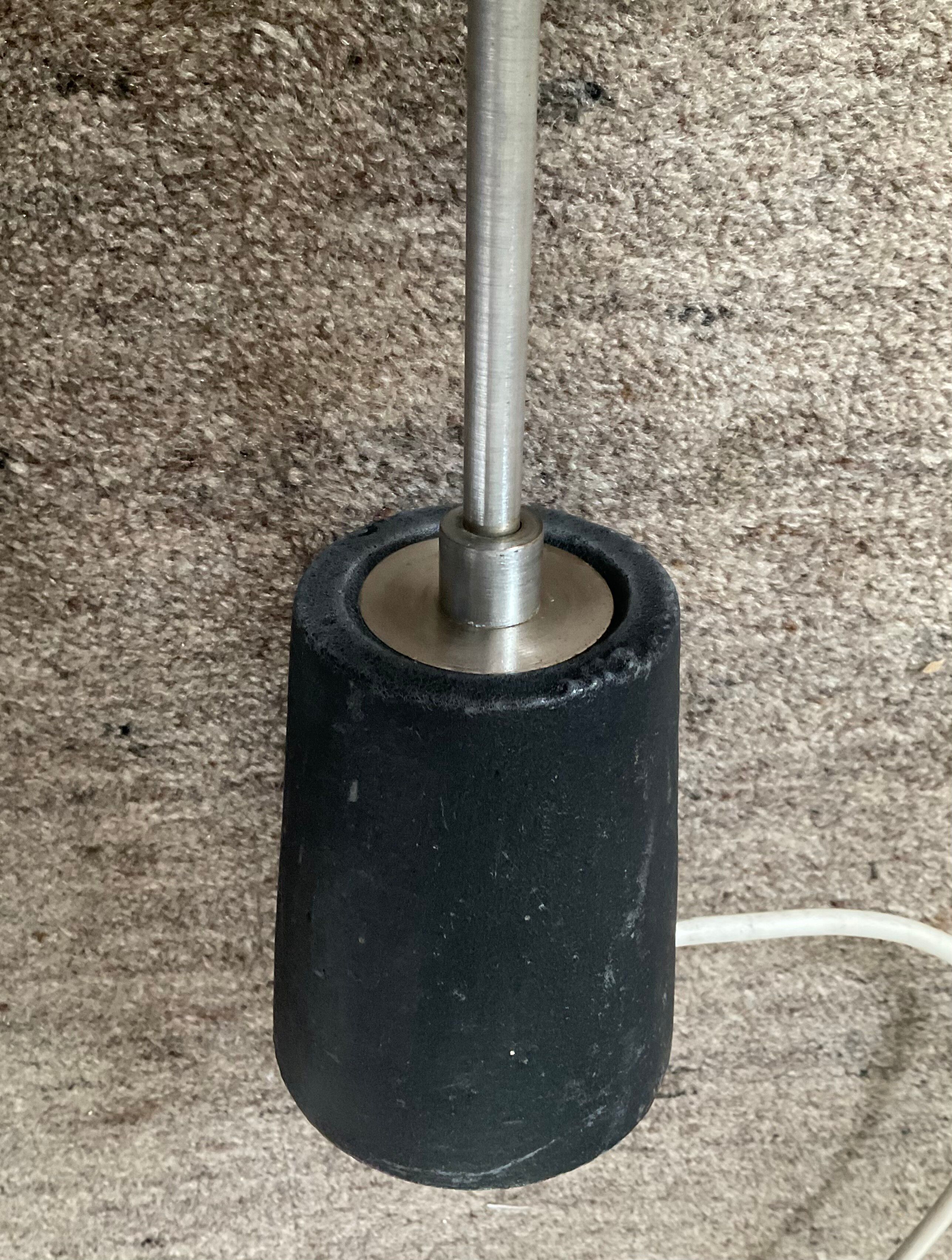 Minimalist floor lamp in cast iron and chrome metal