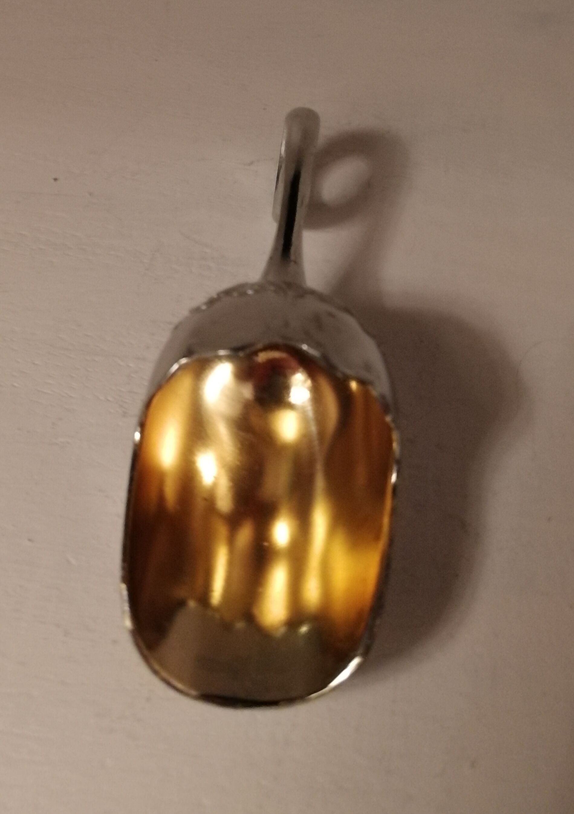 Sugar and sugar shovel in golden silver metal