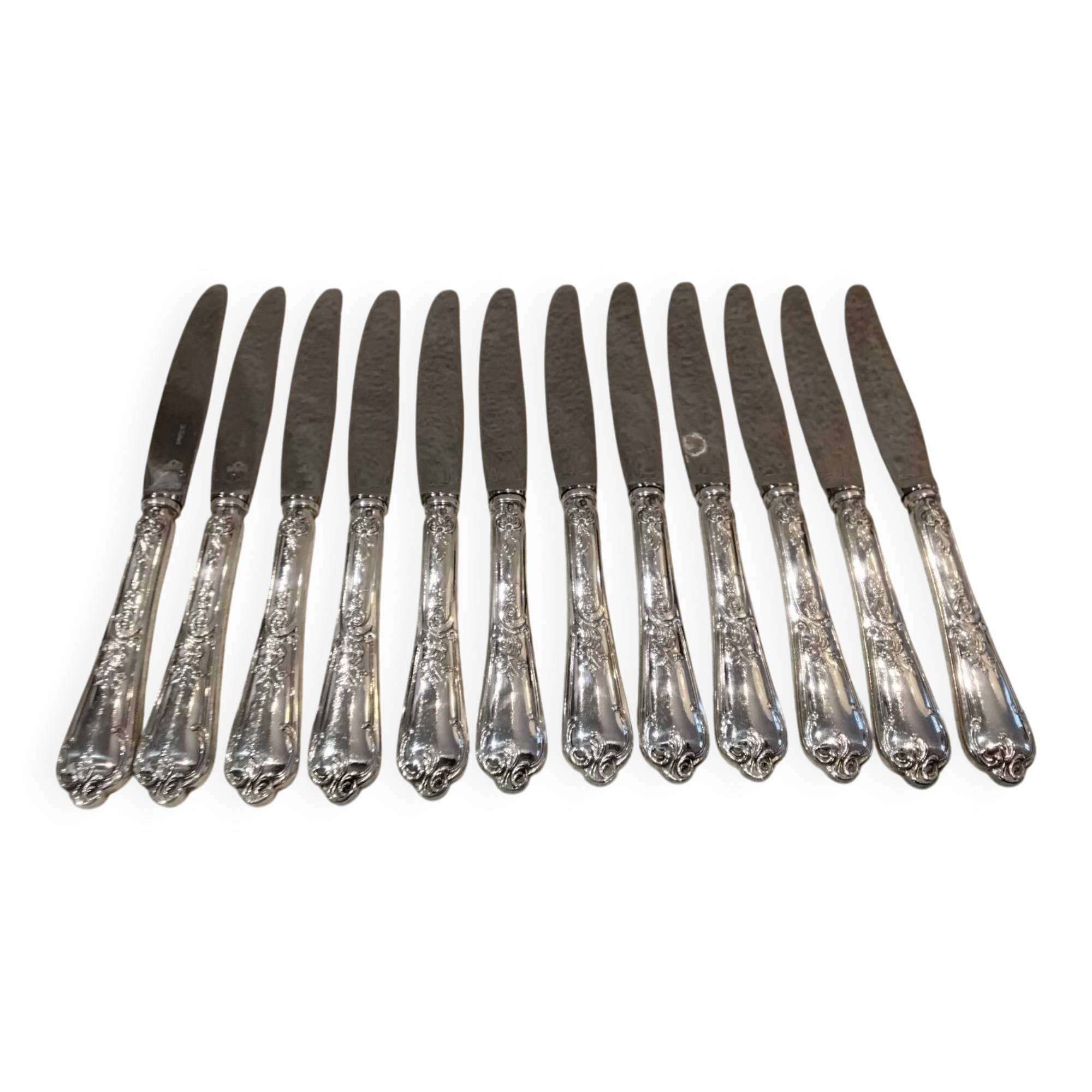 12 silver-plated dessert knives by St Medard, rocaille style, Florian.