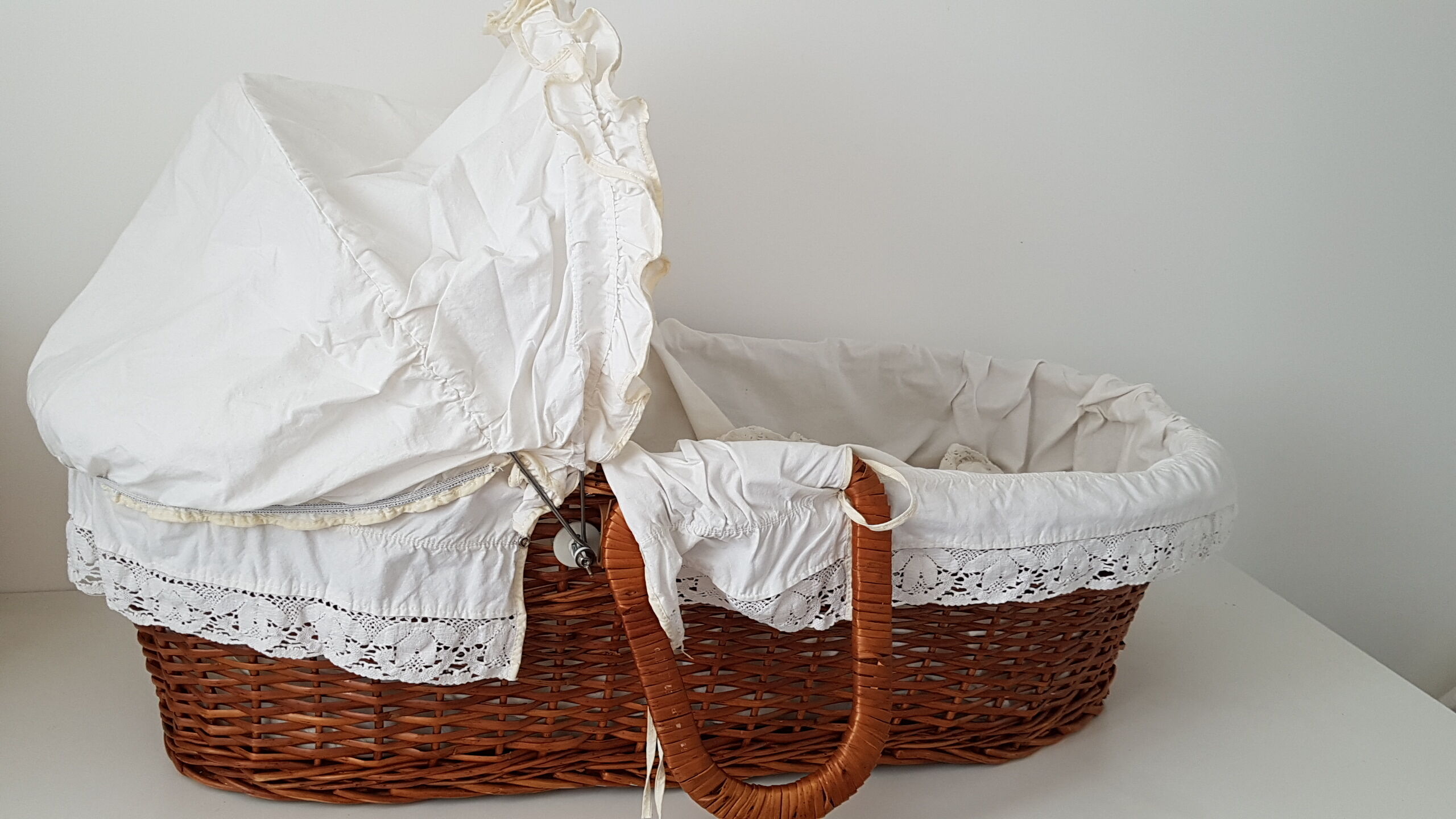 Old rattan bassinet and bedding