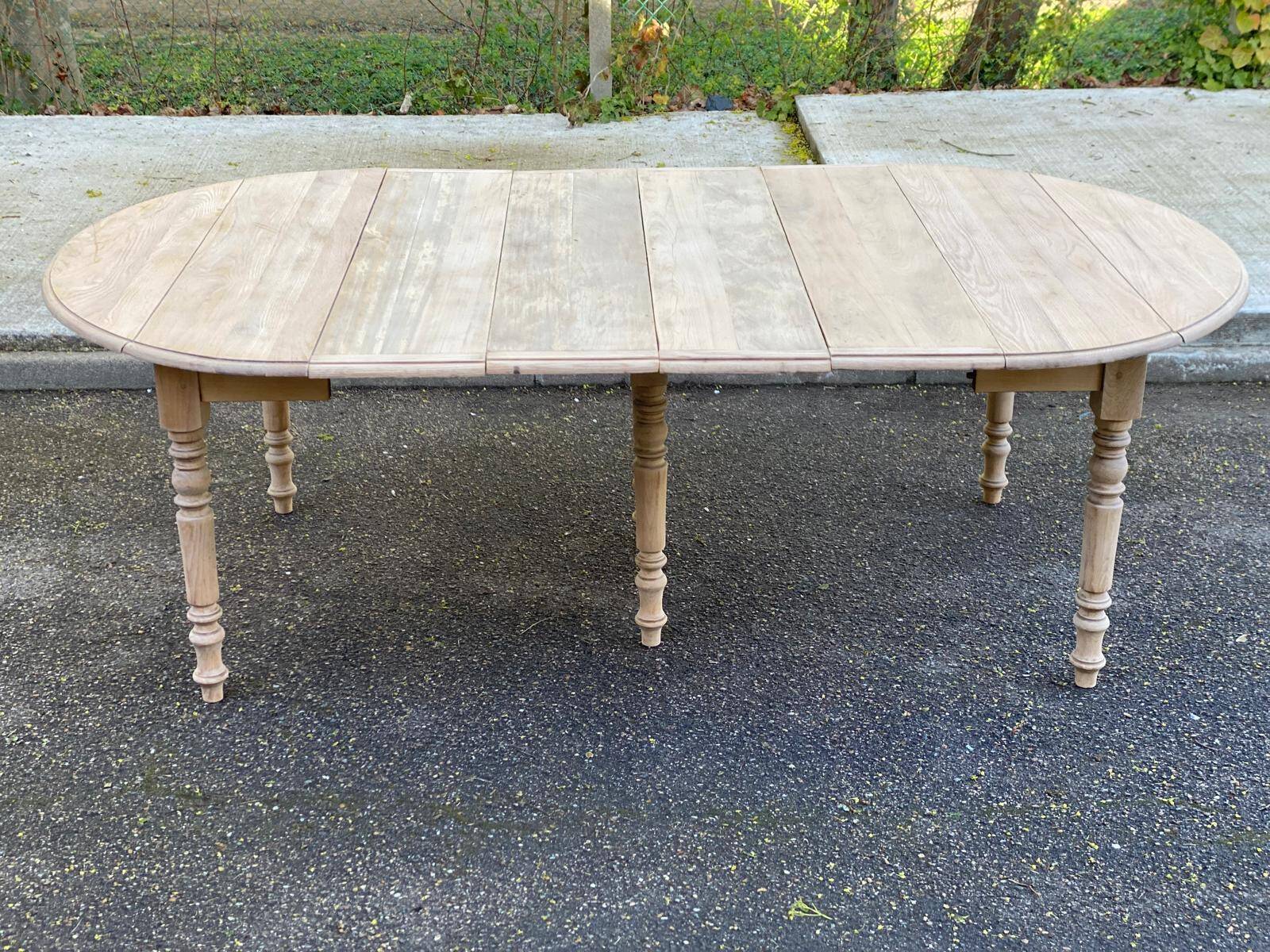Renovated Louis Philippe round extendable dining table with 4 leaves.