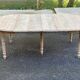 Renovated Louis Philippe round extendable dining table with 4 leaves.