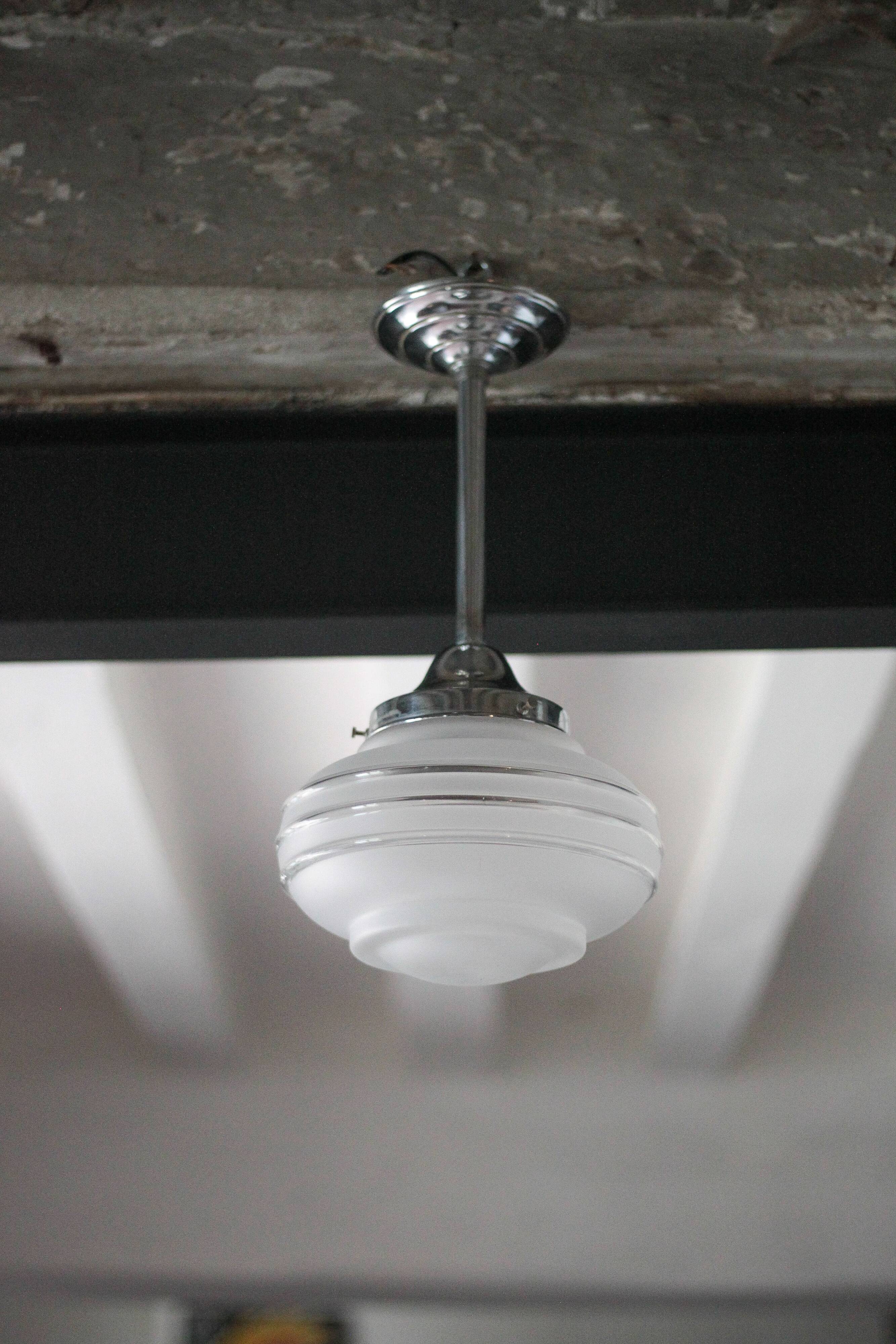 Art Deco pendant light, chrome metal suspension and glass globe, ceiling lamp.