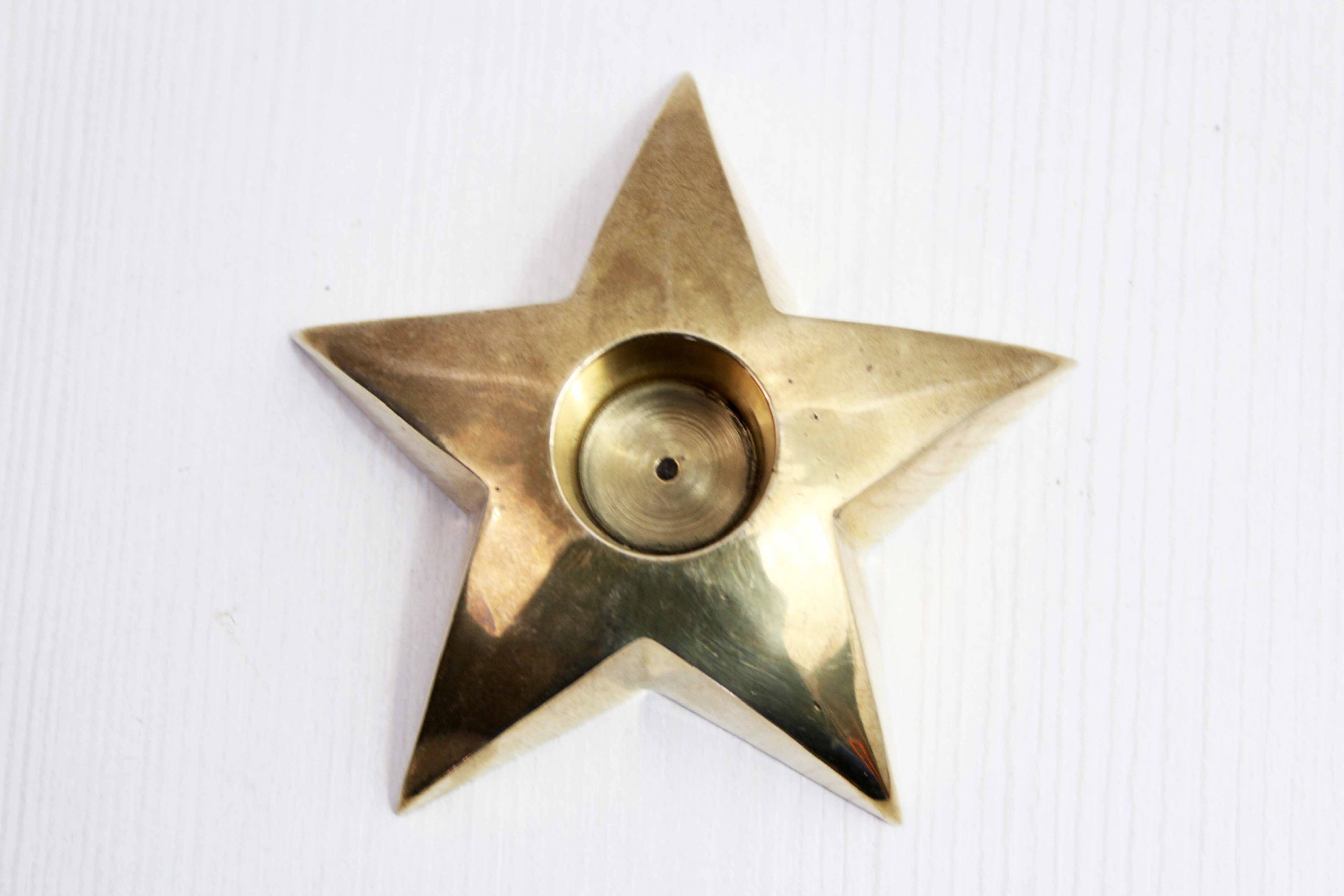 Star-shaped brass candle holder