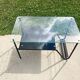 Metal and glass coffee table with magazine rack by Roche Bobois from the 1950s.