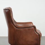 Cognac brown cow leather armchair with decorative nail finish