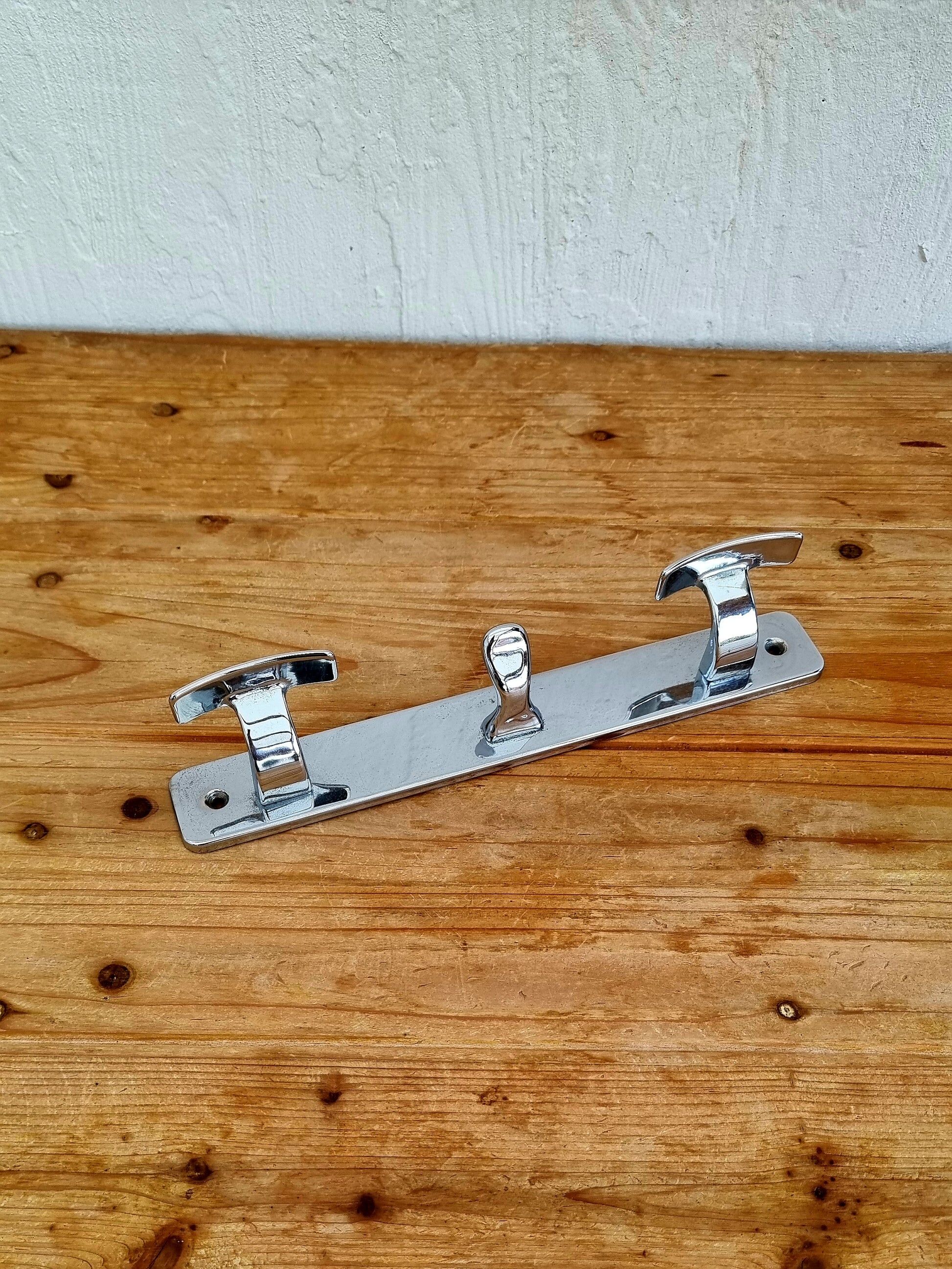 Vintage chrome wall coat rack with three hooks.