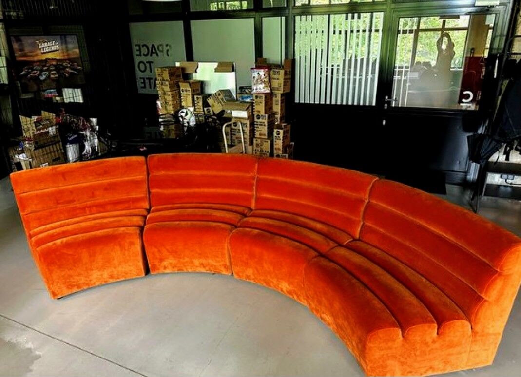 Burnt orange modular sofa for four with a futuristic design.