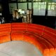 Burnt orange modular sofa for four with a futuristic design.