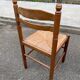 4 dining or kitchen chairs made of solid wood with rush seats.