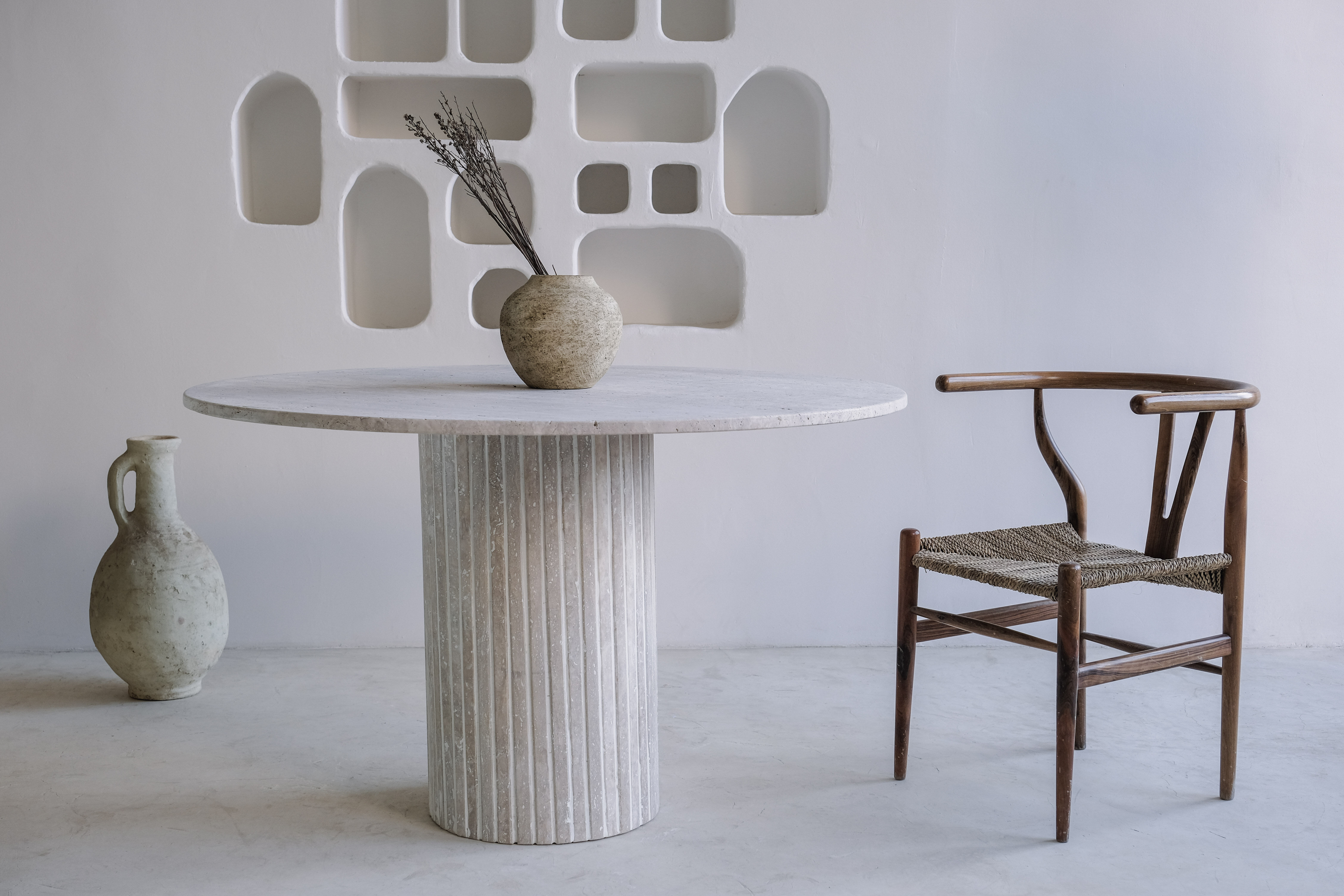 Omega circular dining table in natural travertine