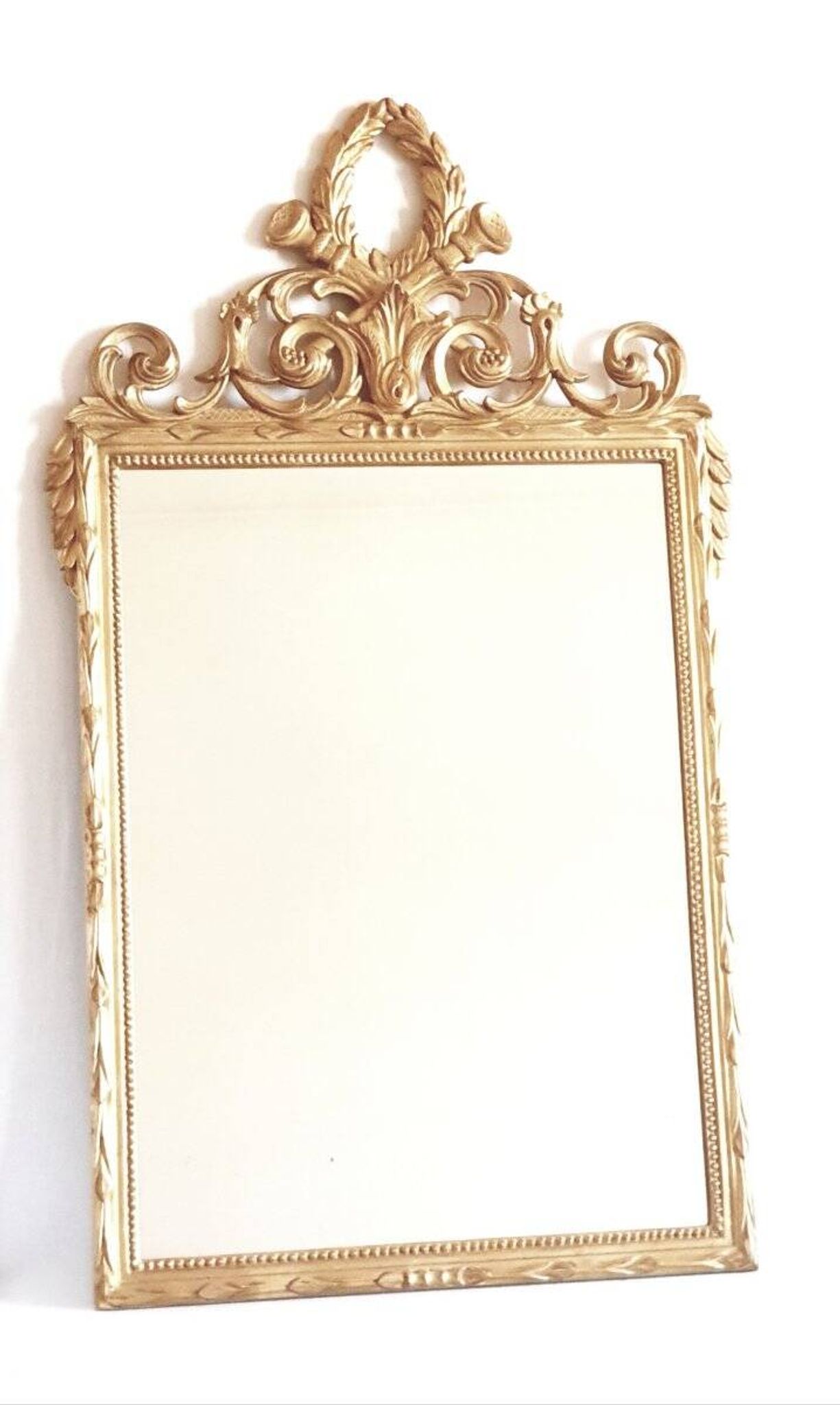 Golden mirror in the Louis XVI style from the 20th century.