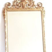 Golden mirror in the Louis XVI style from the 20th century.