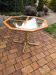 Octagonal table in brass and glass, brown and straw yellow — Hollywood Regency style.
