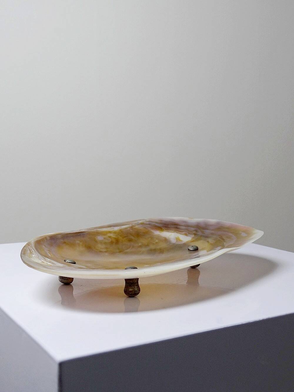 Antique mother-of-pearl tripod bowl emptier with silver metal legs