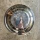 Round, hollow silver-plated metal dish