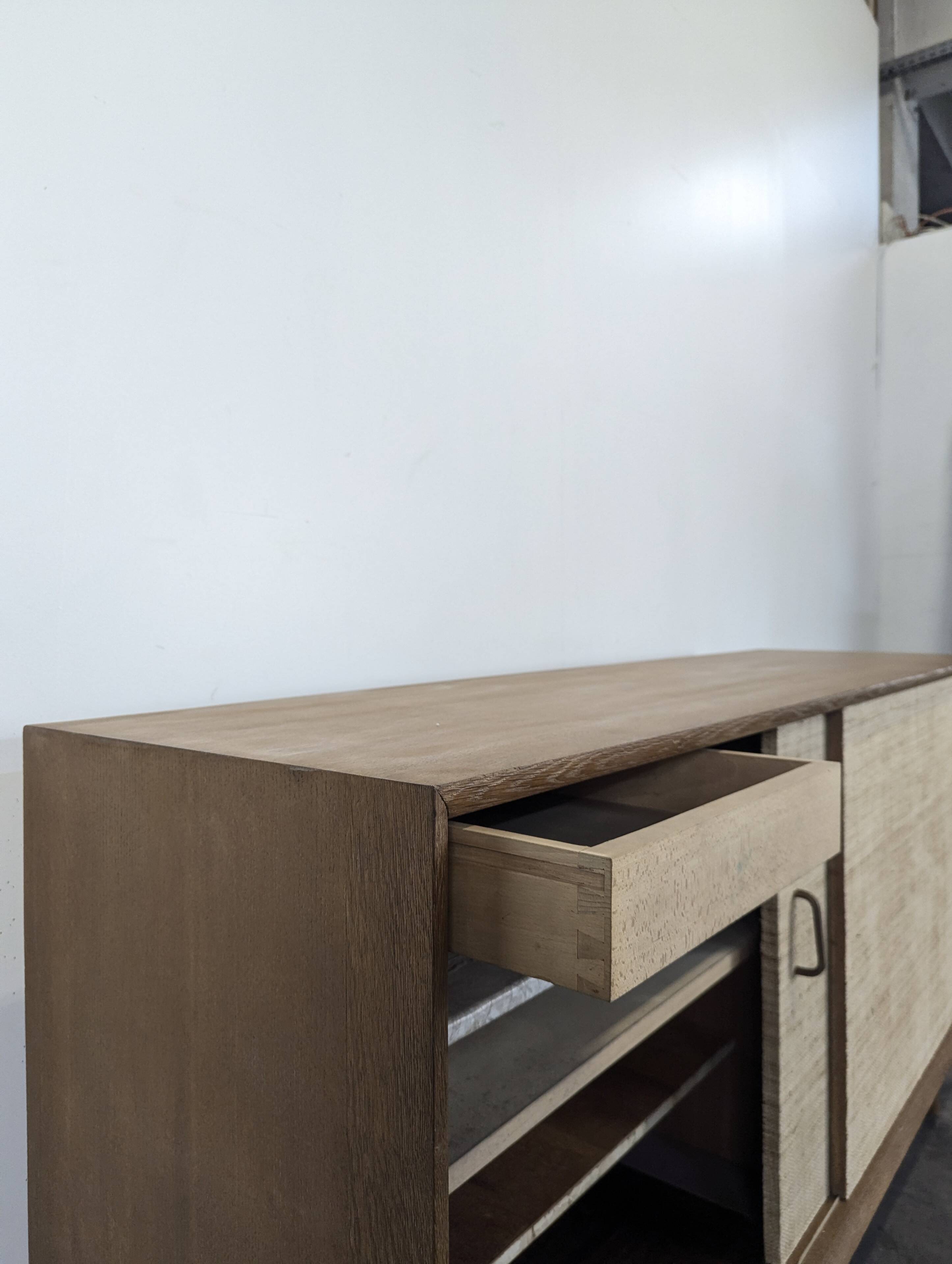 Modernist sideboard in oak with rattan doors.