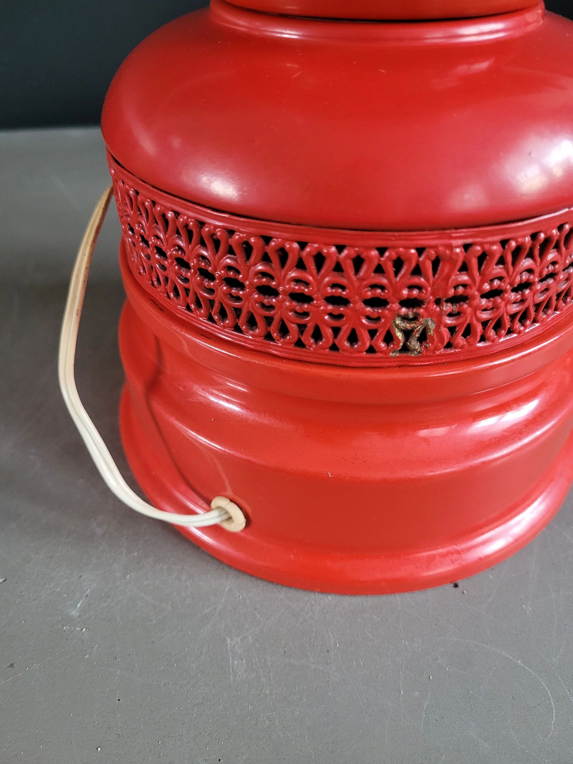 Vintage globe lamp with a metal base, perforated and lacquered in red.