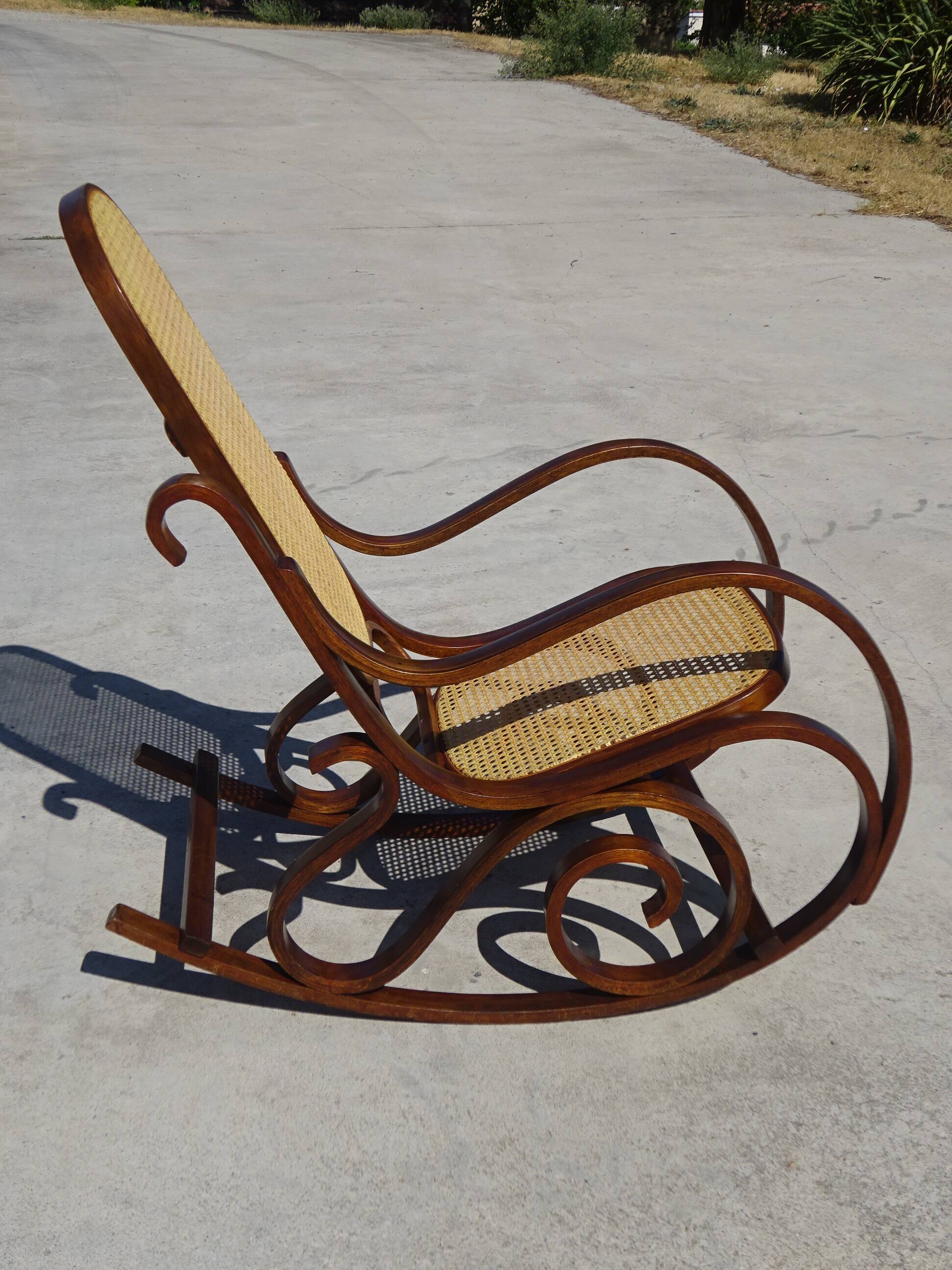 Vintage wooden rocking chair with caning
