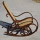 Vintage wooden rocking chair with caning