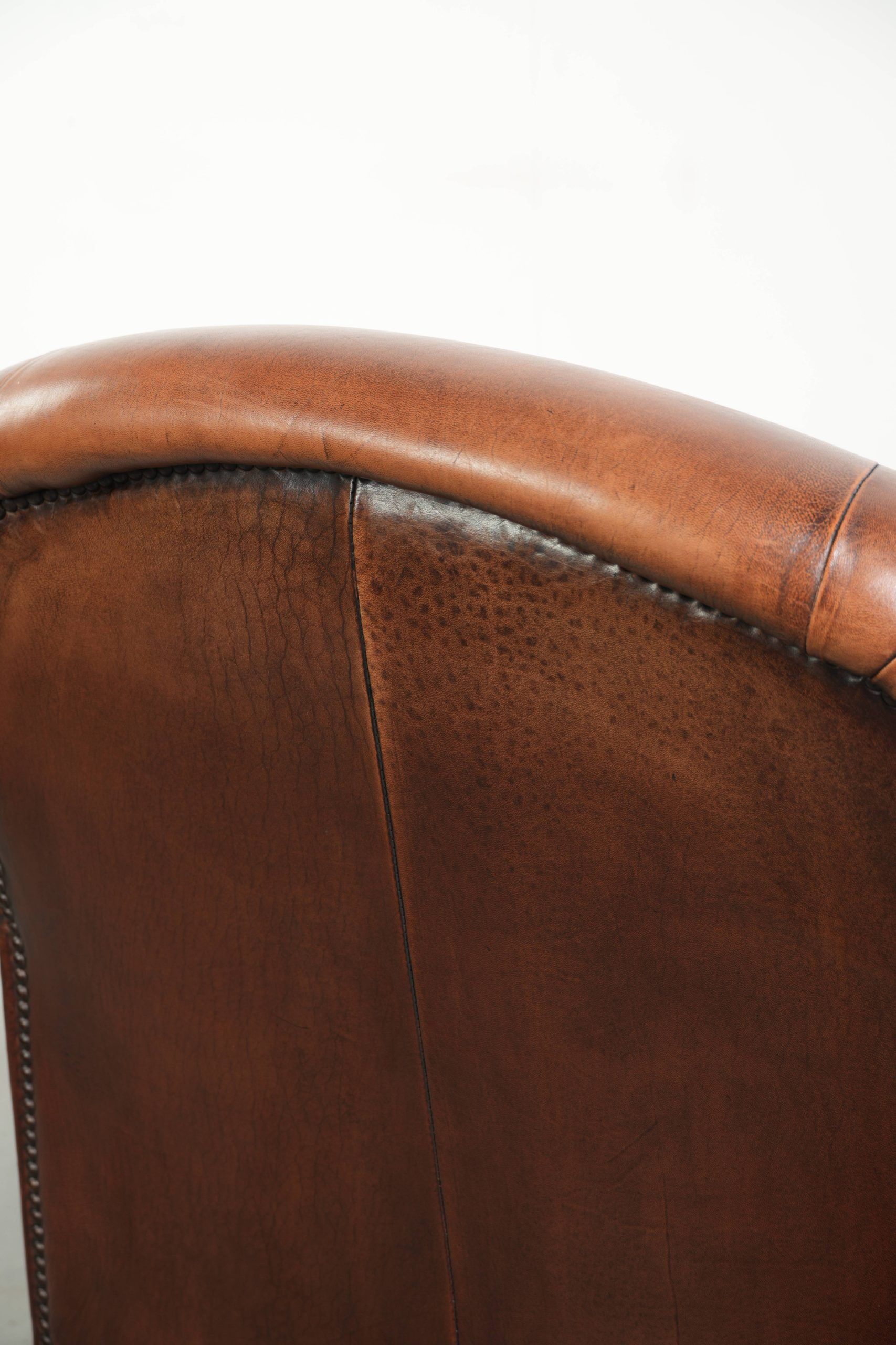 Sheepskin armchair with comfortable seat and finished with decorative nails