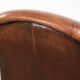Sheepskin armchair with comfortable seat and finished with decorative nails
