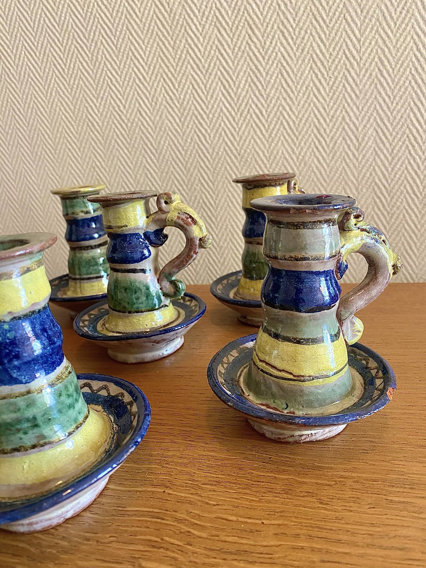 Many old glazed terracotta candlesticks.