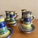 Many old glazed terracotta candlesticks.
