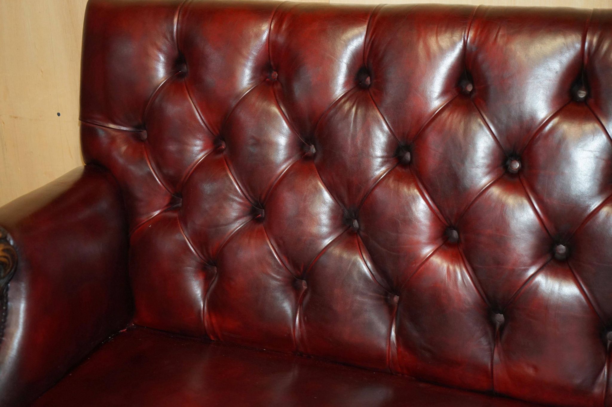 Victorian Chesterfield leather sofa with carved lion heads.