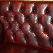 Victorian Chesterfield leather sofa with carved lion heads.