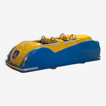 Yellow and blue car subject of sheet metal merry-go-round 1952