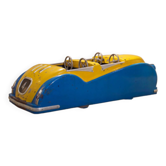 Yellow and blue car subject of sheet metal merry-go-round 1952