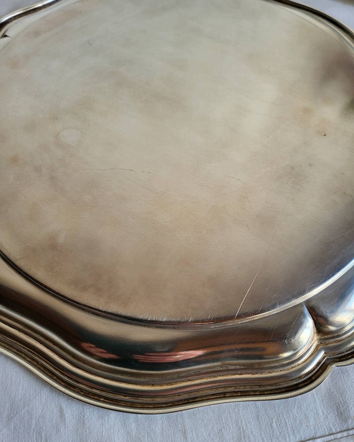 Round silver-plated serving dish with a glass base.