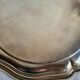 Round silver-plated serving dish with a glass base.