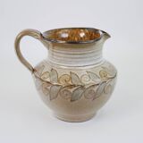 Glazed ceramic jug with plant decoration