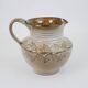 Glazed ceramic jug with plant decoration